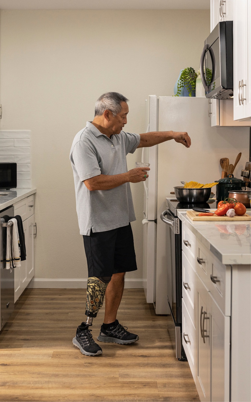 Man with prosthetic leg cooking