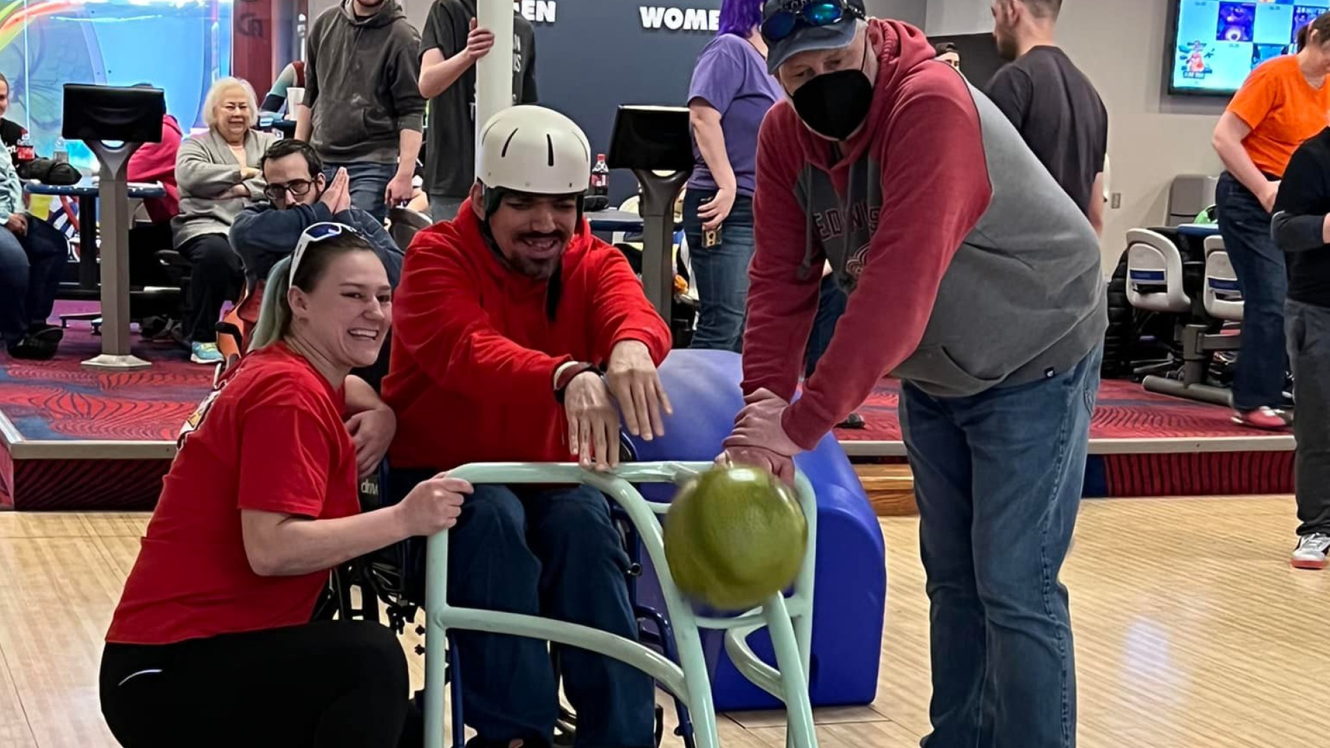 Man participating in, and enjoying accessible bowling with Disability Network Mid-Michigan at a local Midland, Michigan bowling alley