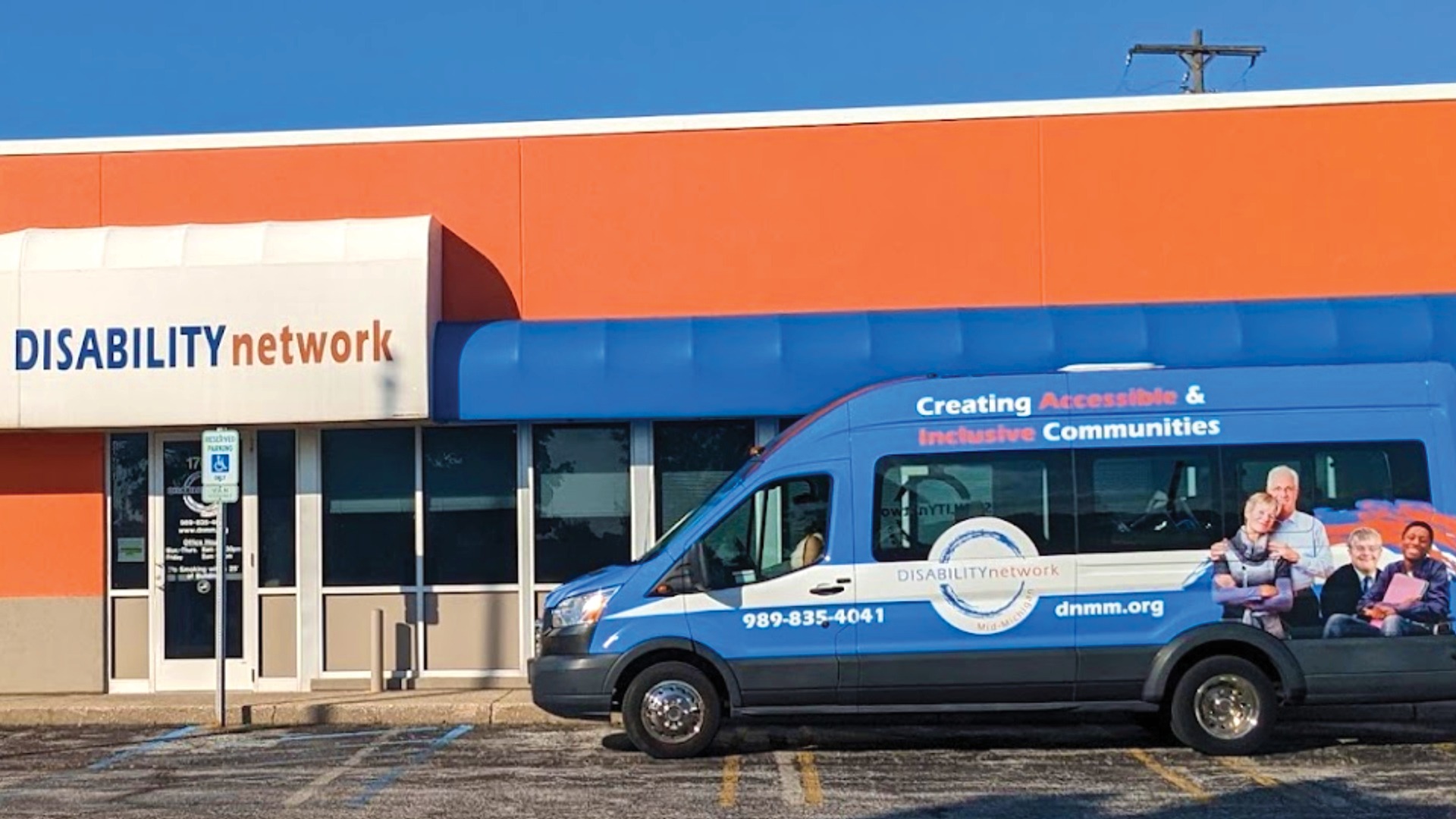 Disability Network Mid-Michigan office front with their van parked in front of windows in parking lot