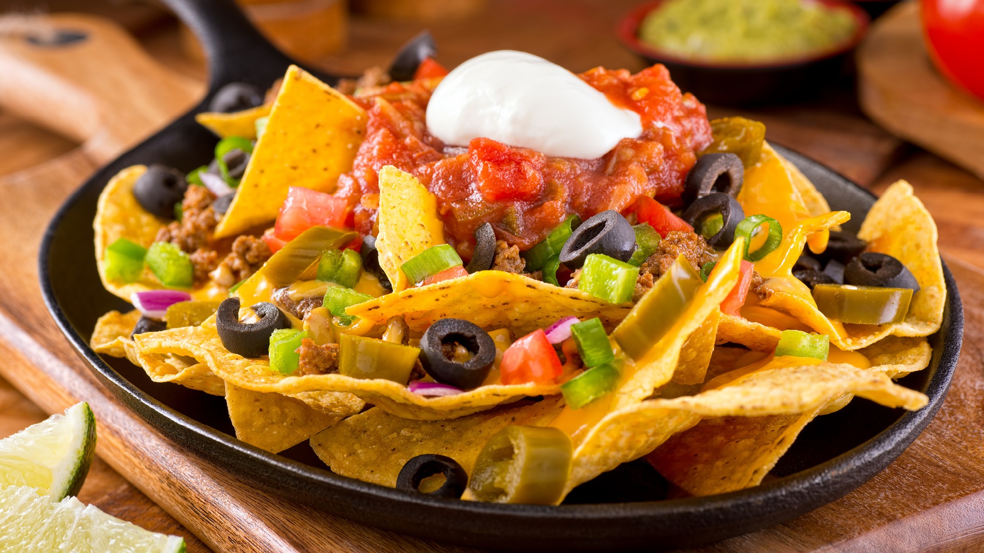 Nachos in a pan with all of the fixing's