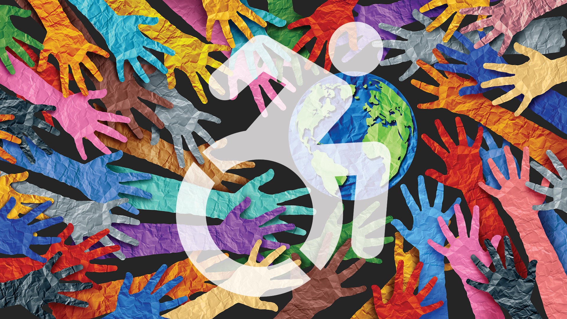 paper hands of all colors reaching toward paper globe with disability wheelchair icon superimposed on top